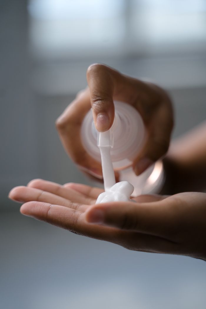 A close-up view of hands applying lotion, ideal for skincare and beauty concepts.